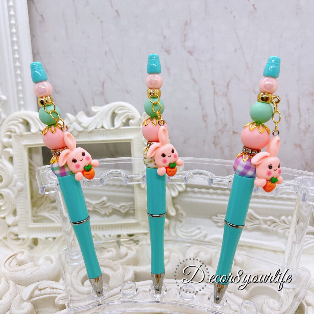 Shop our fun and functional beaded ballpoint pen featuring pastel beads, a Cute charm, and refillable black ink. Perfect for stationery and planner lovers.