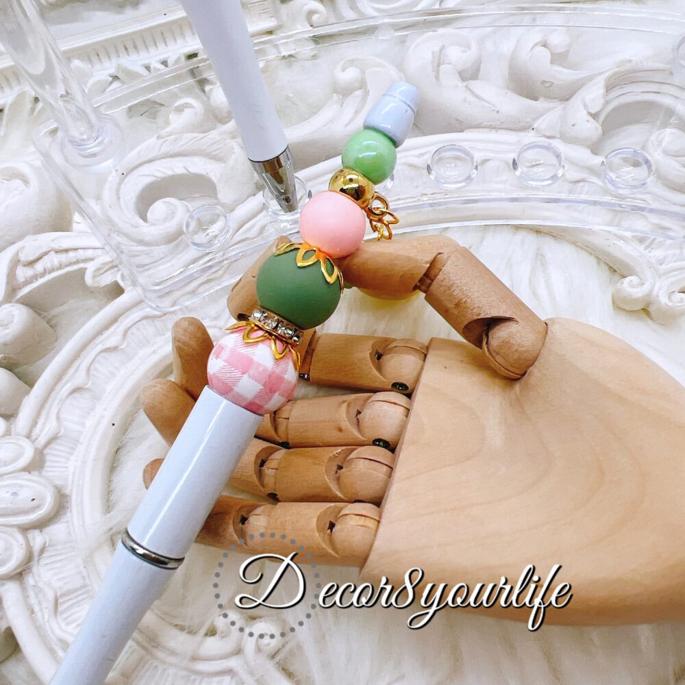 Beaded pens with cute strawberry dangle featuring silicone, wood, and acrylic beads, hand-assembled in the U.S., customizable for a unique writing experience.