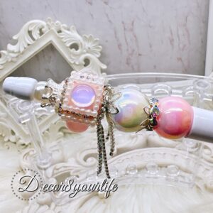 Elegant beaded ballpoint pen with embellished acrylic beads, rhinestone spacers, and silver-tone bead caps on a white base