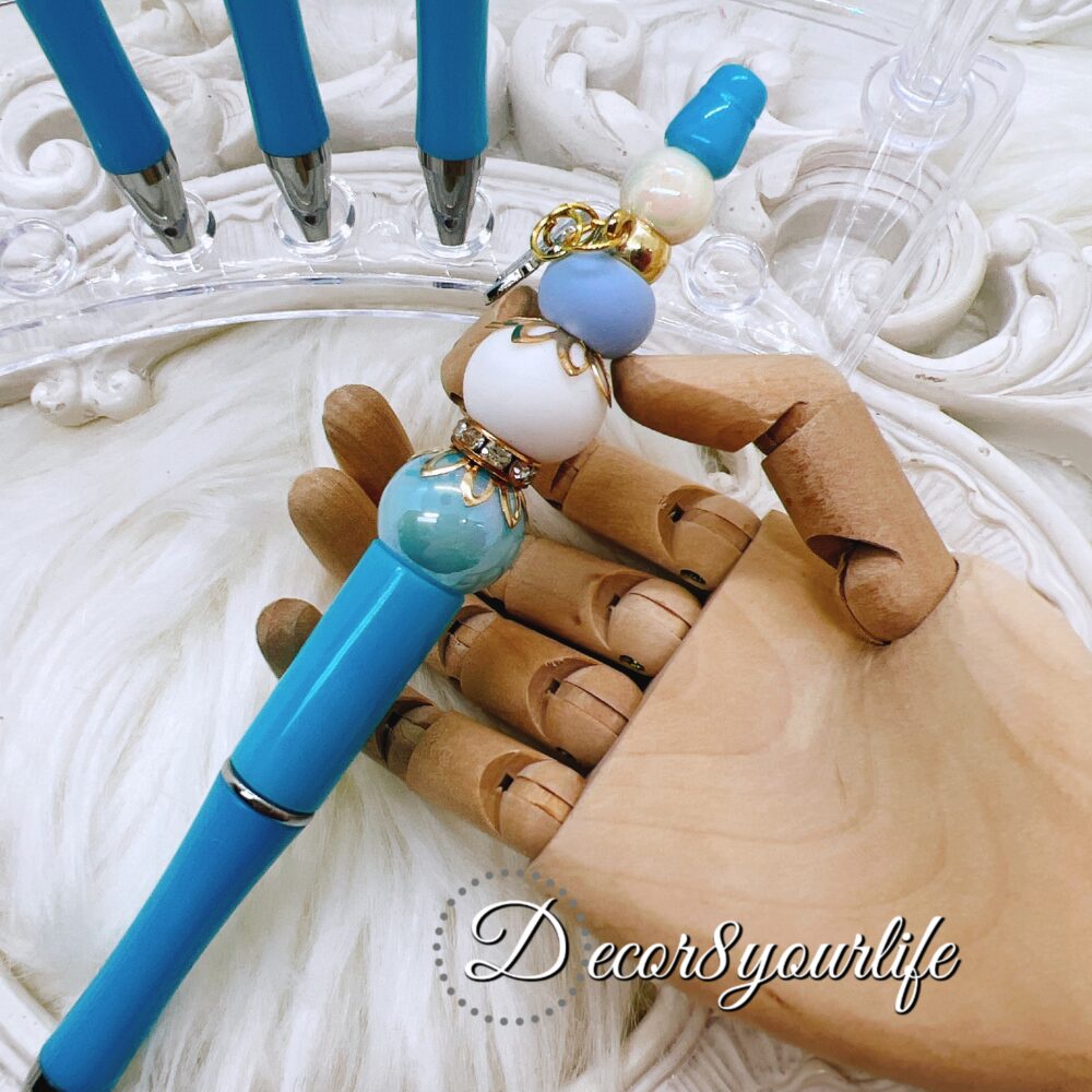 Cinnamoroll beaded ballpoint pen featuring a licensed Sanrio character charm, acrylic and silicone beads, and rhinestone spacers