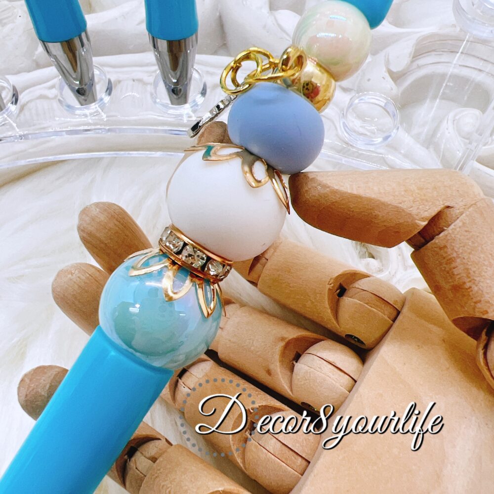 Cinnamoroll beaded ballpoint pen featuring a licensed Sanrio character charm, acrylic and silicone beads, and rhinestone spacers