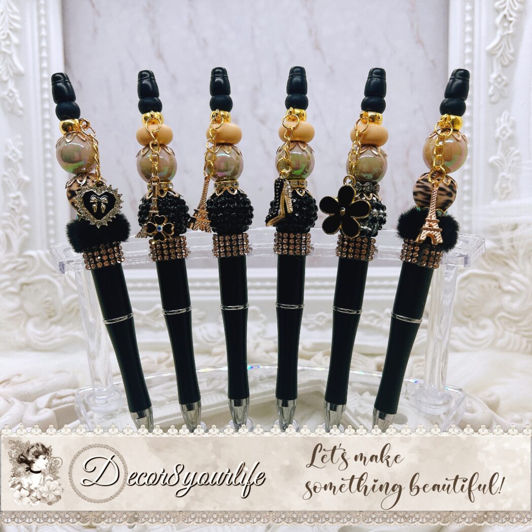 Elegant beaded pens with black and gold beads, charms, and stylish accents. Luxury writing pens sold individually.