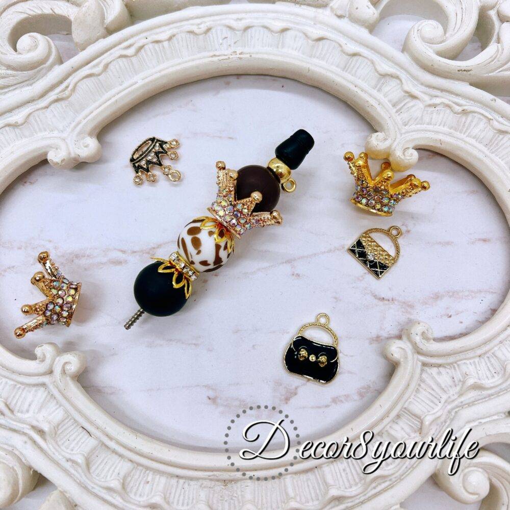 High-end bead and charm kit for custom pen decoration featuring leopard and crown accents.