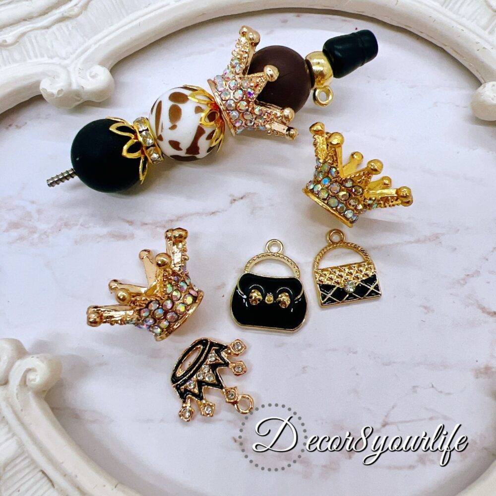 Leopard print bead and charm kit for beadable pens with crown charms, purse charms, and rhinestone accents.