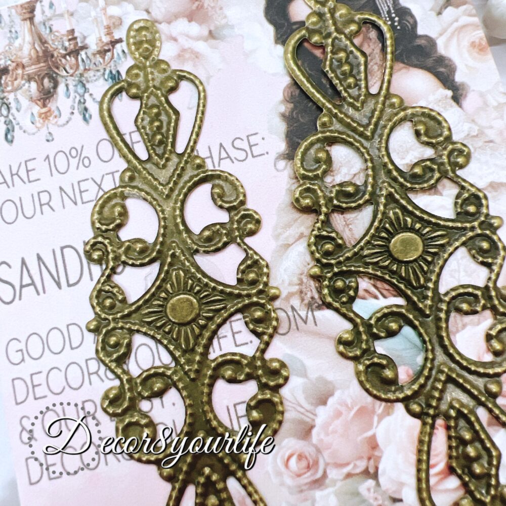 Pack of two elegant filigree metal embellishments, measuring 3.25 x 1.5 inches, perfect for DIY crafts, scrapbooks, and journals.