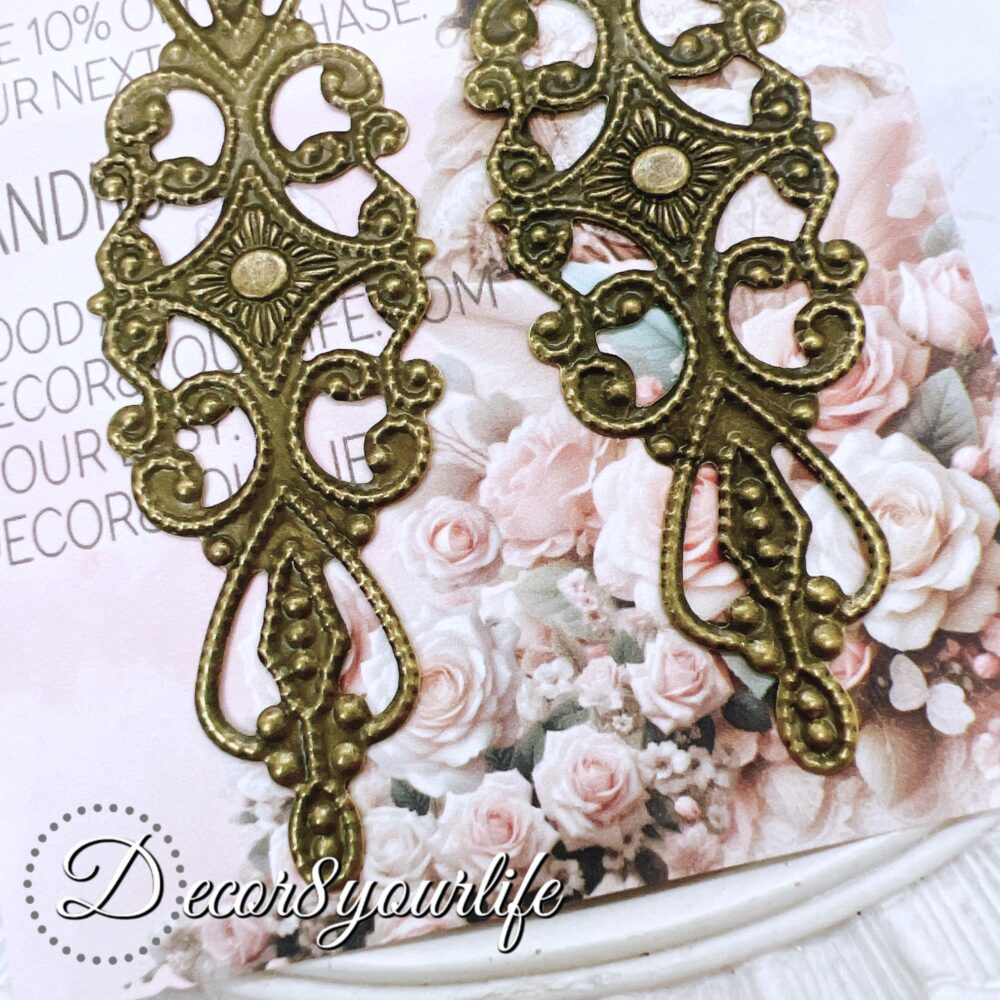 Pack of two elegant filigree metal embellishments, measuring 3.25 x 1.5 inches, perfect for DIY crafts, scrapbooks, and journals.