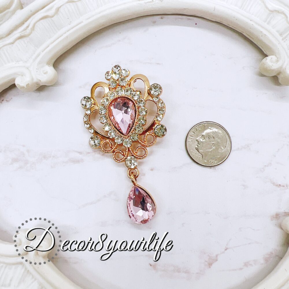 Elegant pink crystal and rhinestone brooch for craft embellishments, scrapbooks, bridal decor, and fashion.