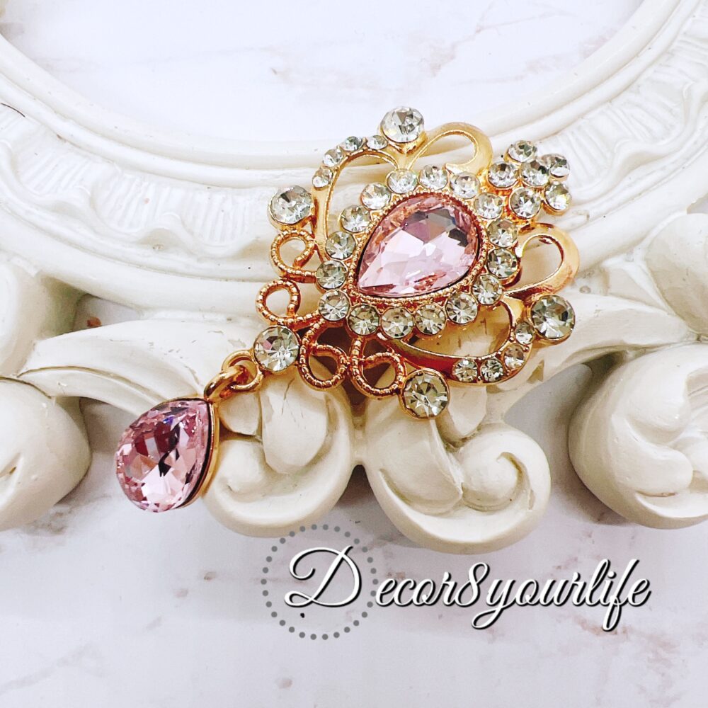 Elegant pink crystal and rhinestone brooch for craft embellishments, scrapbooks, bridal decor, and fashion.