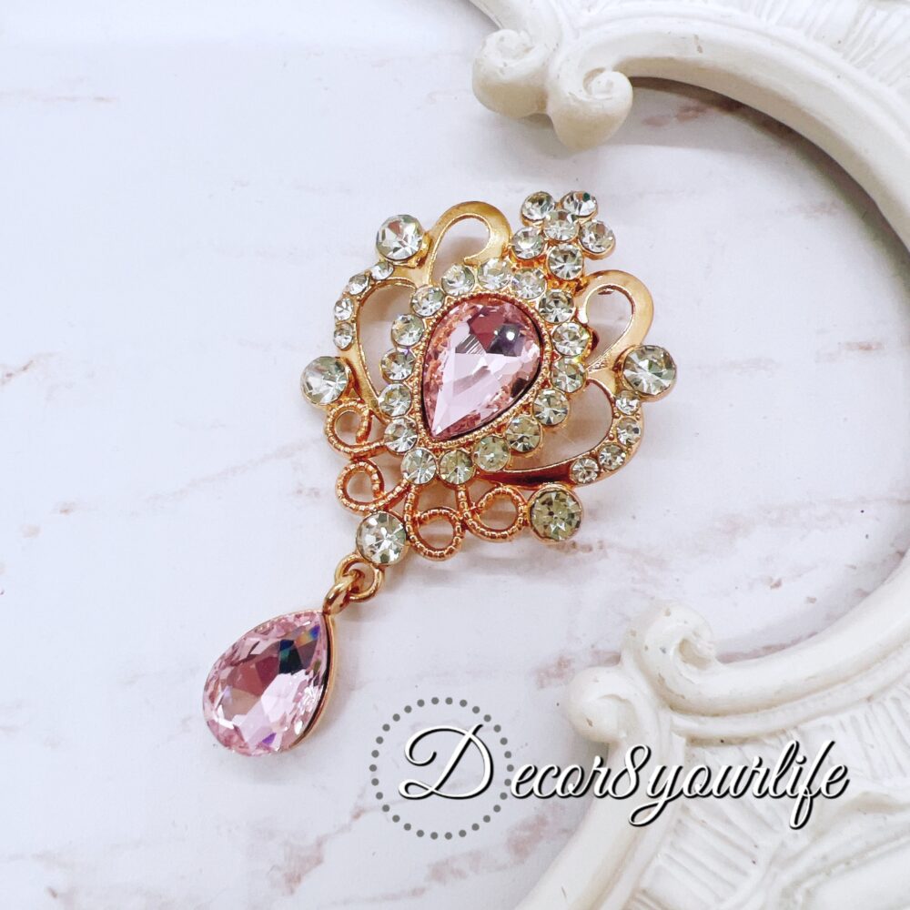 Elegant pink crystal and rhinestone brooch for craft embellishments, scrapbooks, bridal decor, and fashion.