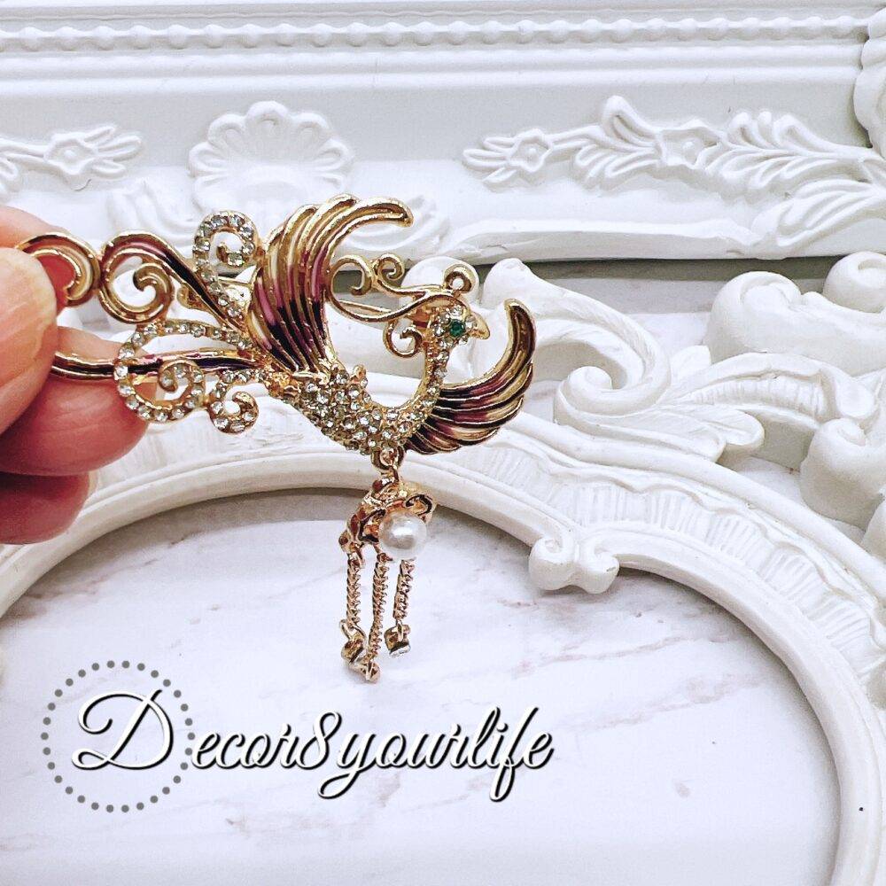 Gold Phoenix Rhinestone Brooch with pearl accents and dangling chains for DIY wedding decor and craft projects.