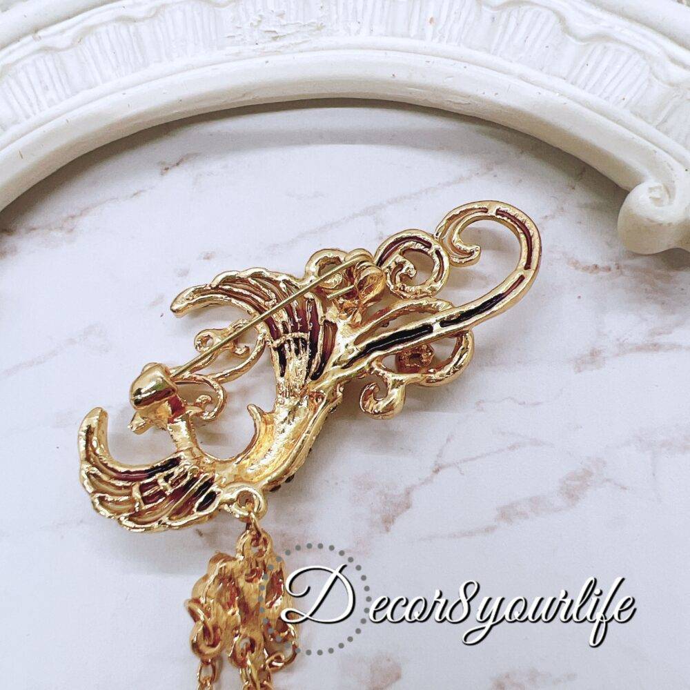 Gold Phoenix Rhinestone Brooch with pearl accents and dangling chains for DIY wedding decor and craft projects.