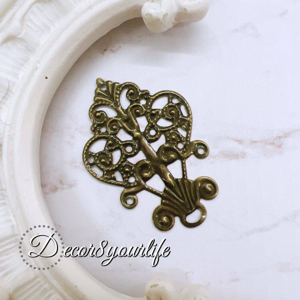 Antique filigree metal embellishment for crafts, pack of 2, intricate design for scrapbook and DIY decor.