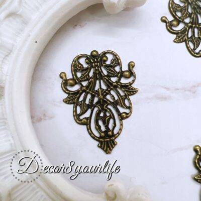 Antique filigree metal embellishment for crafts, pack of 2, intricate design for scrapbook and DIY decor.