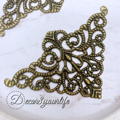 Elegant filigree metal corner embellishment in antique style, perfect for scrapbooking and crafting