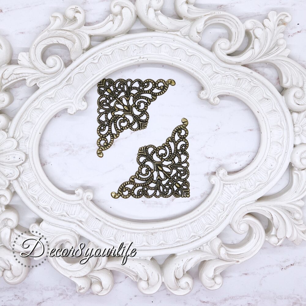 Elegant filigree metal corner embellishment in antique style, perfect for scrapbooking and crafting