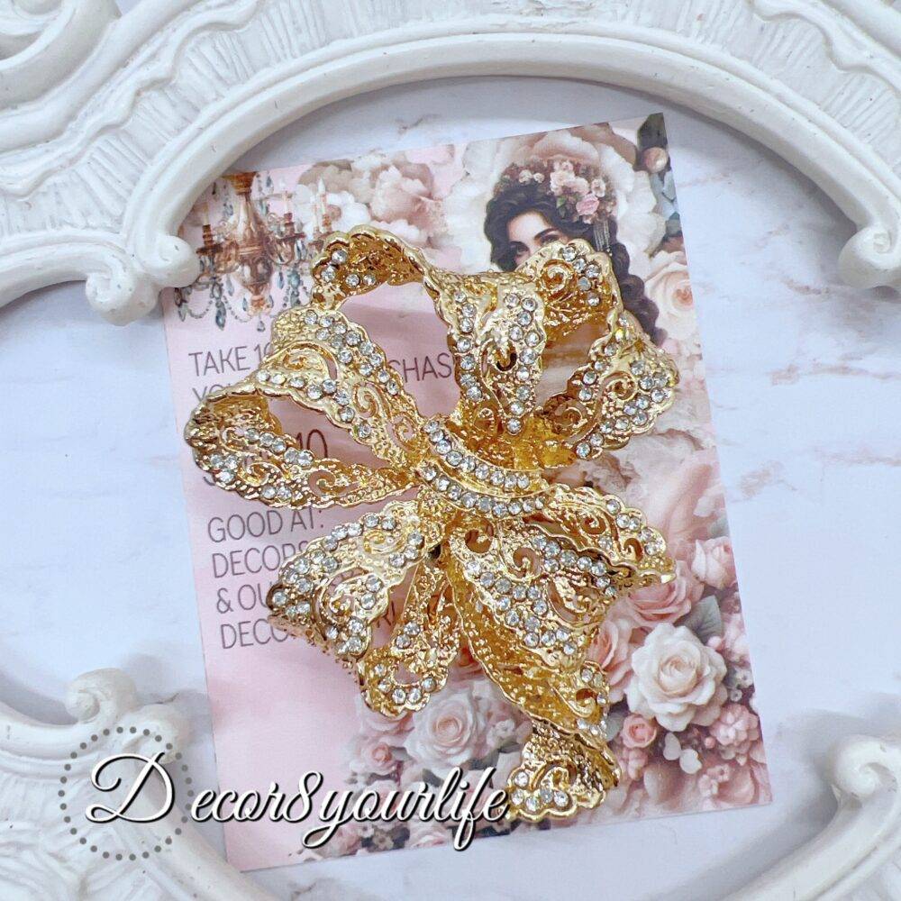 Large rhinestone bow brooch in gold-tone with intricate detailing, ideal for crafts and bridal decor.