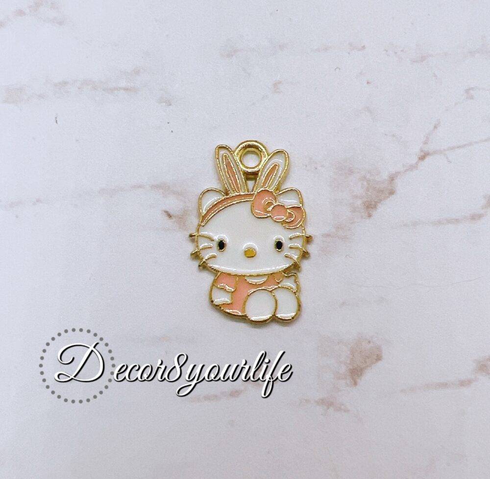 Licensed Sanrio Hello Kitty charm in gold and pastel pink with bunny ears, perfect for crafting and DIY.