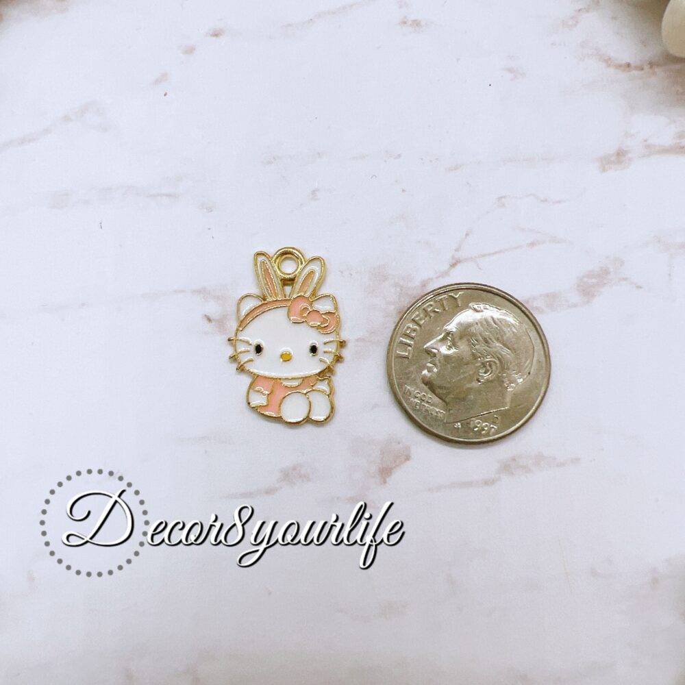 Licensed Sanrio Hello Kitty charm in gold and pastel pink with bunny ears, perfect for crafting and DIY.