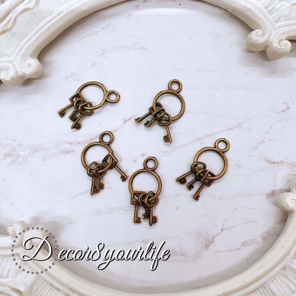 Metal key charms for crafts - vintage bronze embellishments perfect for scrapbooking, journals, mini albums, mixed media, and beadable pens. High-quality, antique-style key charms add rustic charm to DIY projects.