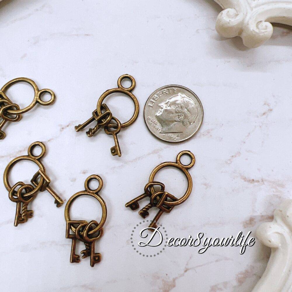 Metal key charms for crafts - vintage bronze embellishments perfect for scrapbooking, journals, mini albums, mixed media, and beadable pens. High-quality, antique-style key charms add rustic charm to DIY projects.