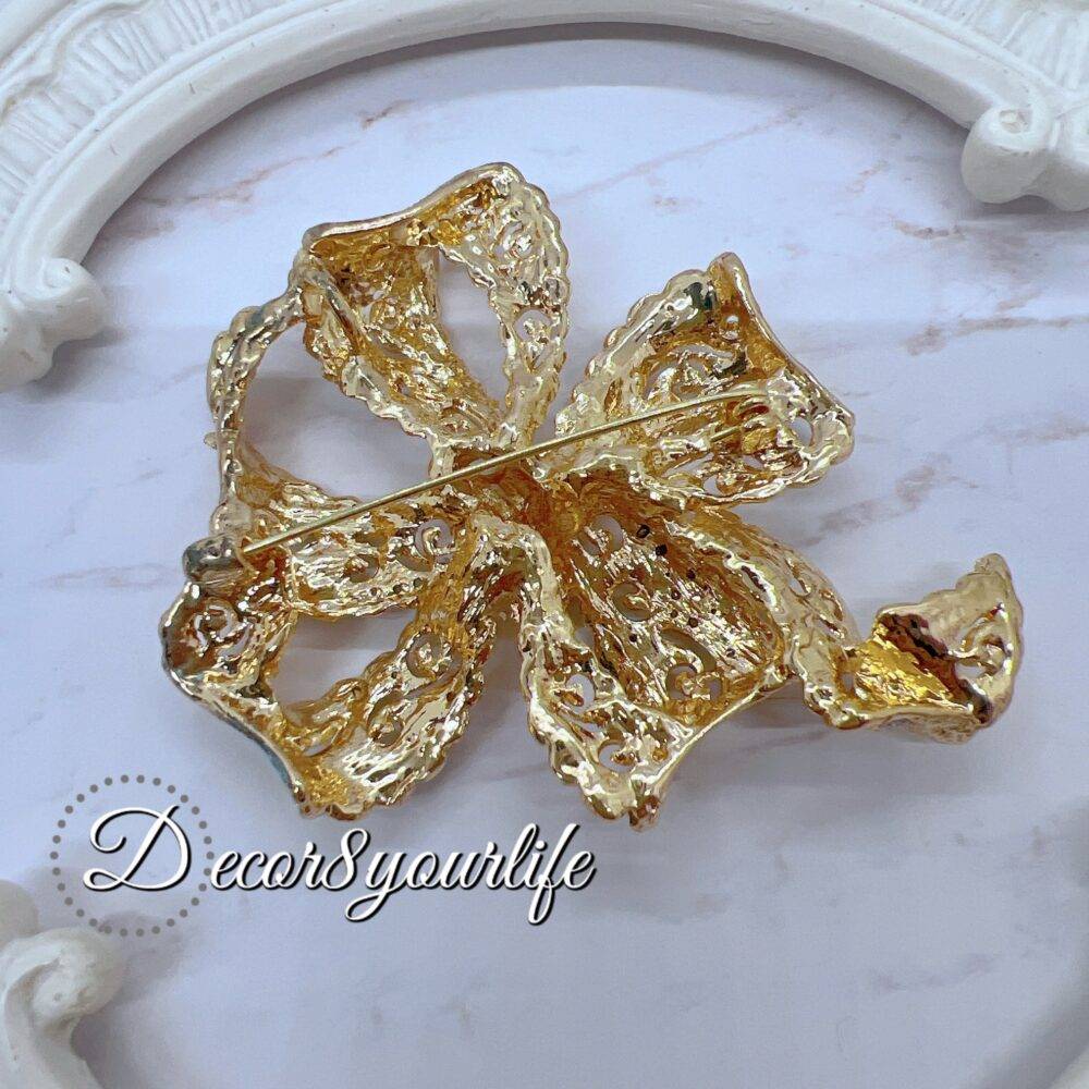 Large rhinestone bow brooch in gold-tone with intricate detailing, ideal for crafts and bridal decor.