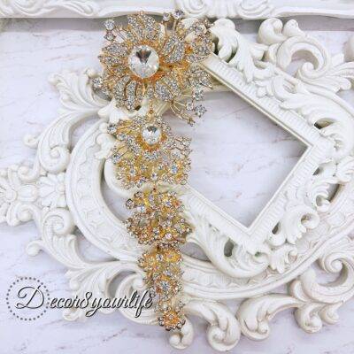 Extra-large gold cascading bridal brooch with rhinestones for DIY wedding decor and craft projects.