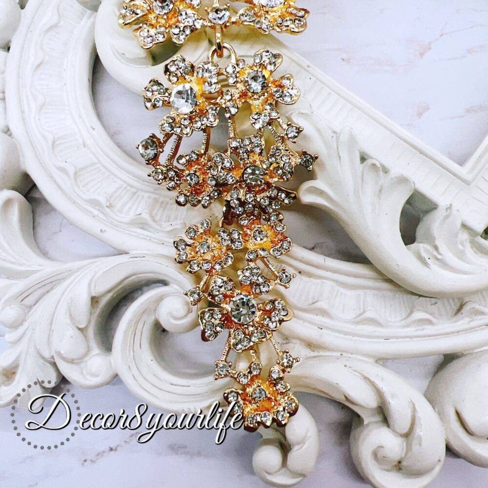 Extra-large gold cascading bridal brooch with rhinestones for DIY wedding decor and craft projects.