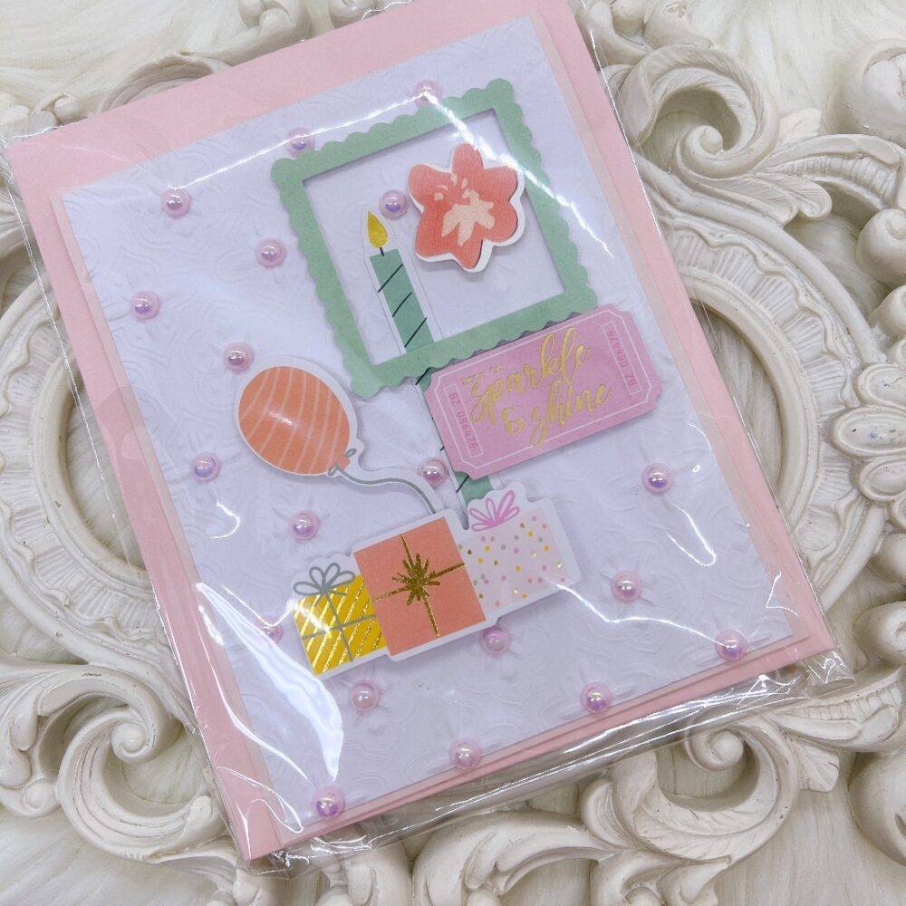 Handmade Greeting Card with Embossed Design and Die-Cut Embellishments.