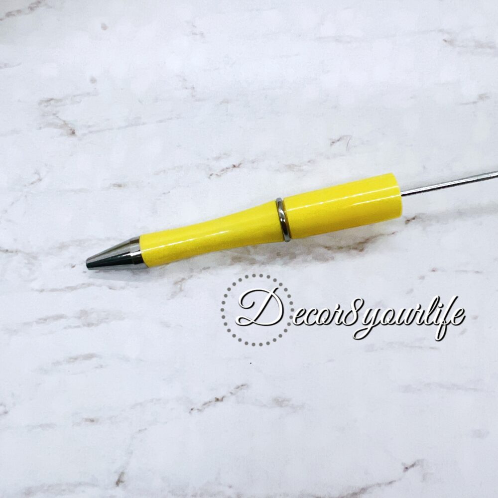 A set of two pastel pom-pom beadable pens featuring a soft, fluffy pom-pom topper and a sleek metal body.,