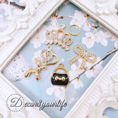 Elegant Black and Gold Charm Grab Bag with rhinestone tiara, purse, bow, heart, and balloon dog—perfect for DIY crafts and jewelry making.