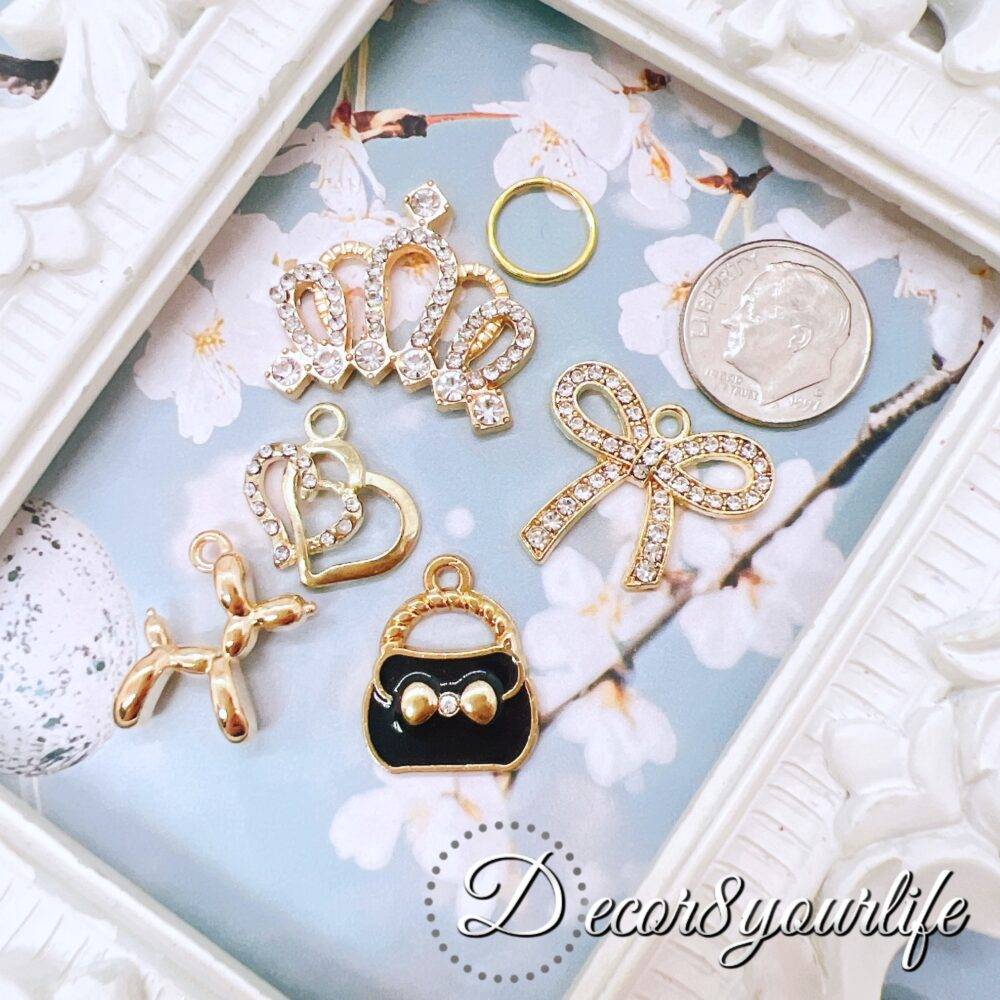 Elegant Black and Gold Charm Grab Bag with rhinestone tiara, purse, bow, heart, and balloon dog—perfect for DIY crafts and jewelry making.