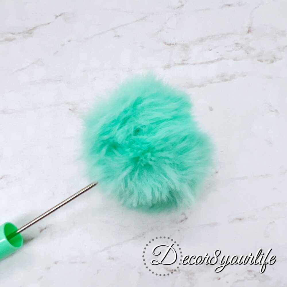 A set of two pastel pom-pom beadable pens featuring a soft, fluffy pom-pom topper and a sleek metal body.