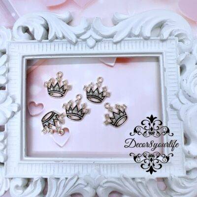 Black Enamel Rhinestone Charms .Set of five black enamel rhinestone crown charms displayed in a vintage white frame, perfect for DIY jewelry and craft projects.