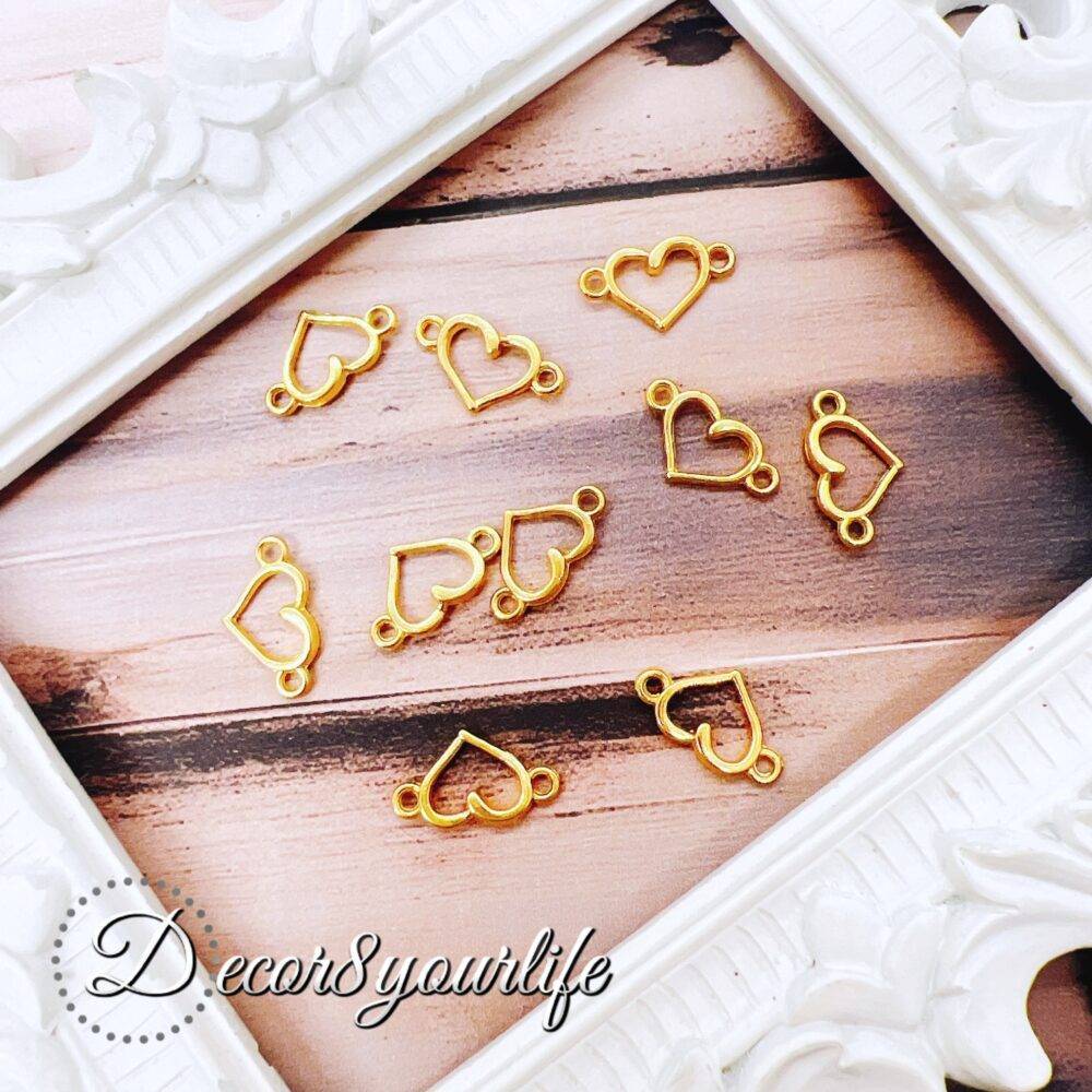 Heart Pendant Connectors. A set of gold-tone heart pendant connectors displayed on a wooden surface with a U.S. dime for size reference.