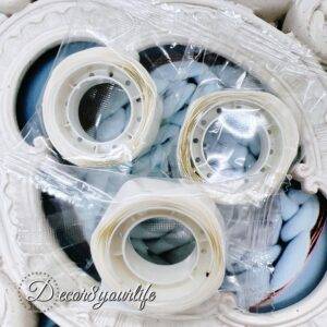 A roll of 100 removable glue dots in clear packaging, ideal for crafting, scrapbooking, and happy mail. These adhesive dots provide a secure hold while being non-permanent, making them perfect for DIY projects.