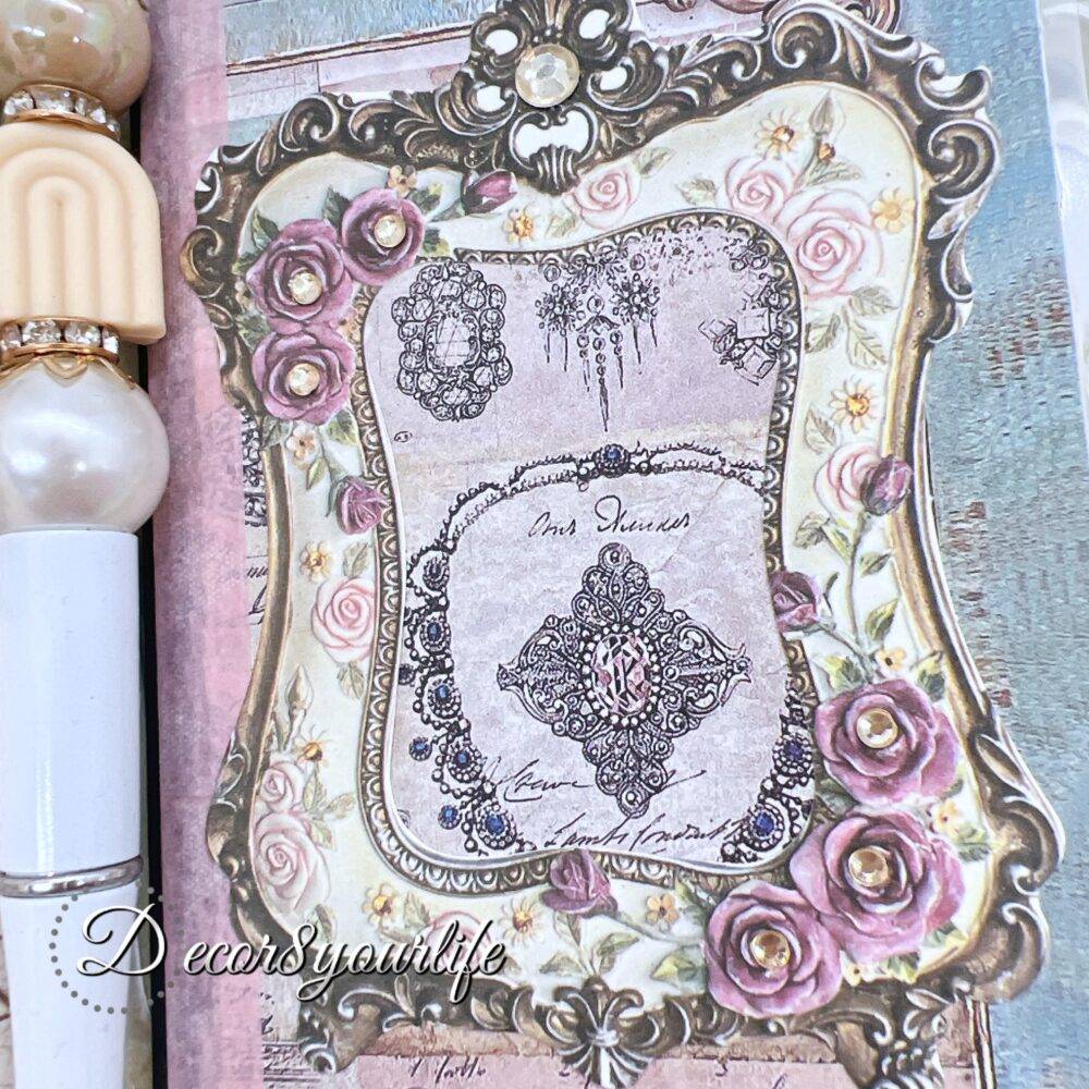 There’s something magical about putting pen to paper, and this shabby chic traveler's notebook makes it even more special! Handcrafted with love, it features two altered mini composition notebooks, a handy pocket for essentials, and the cutest beaded pen to match.