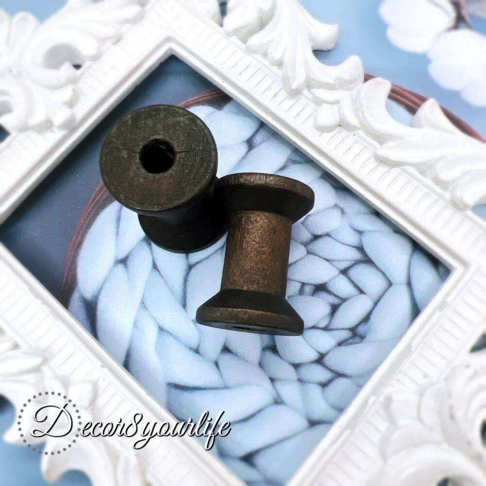 A set of two vintage-style wooden spools with a dark stained finish, perfect for scrapbooking, mixed media, and journal embellishments. Each spool measures approximately 1.25 inches tall.