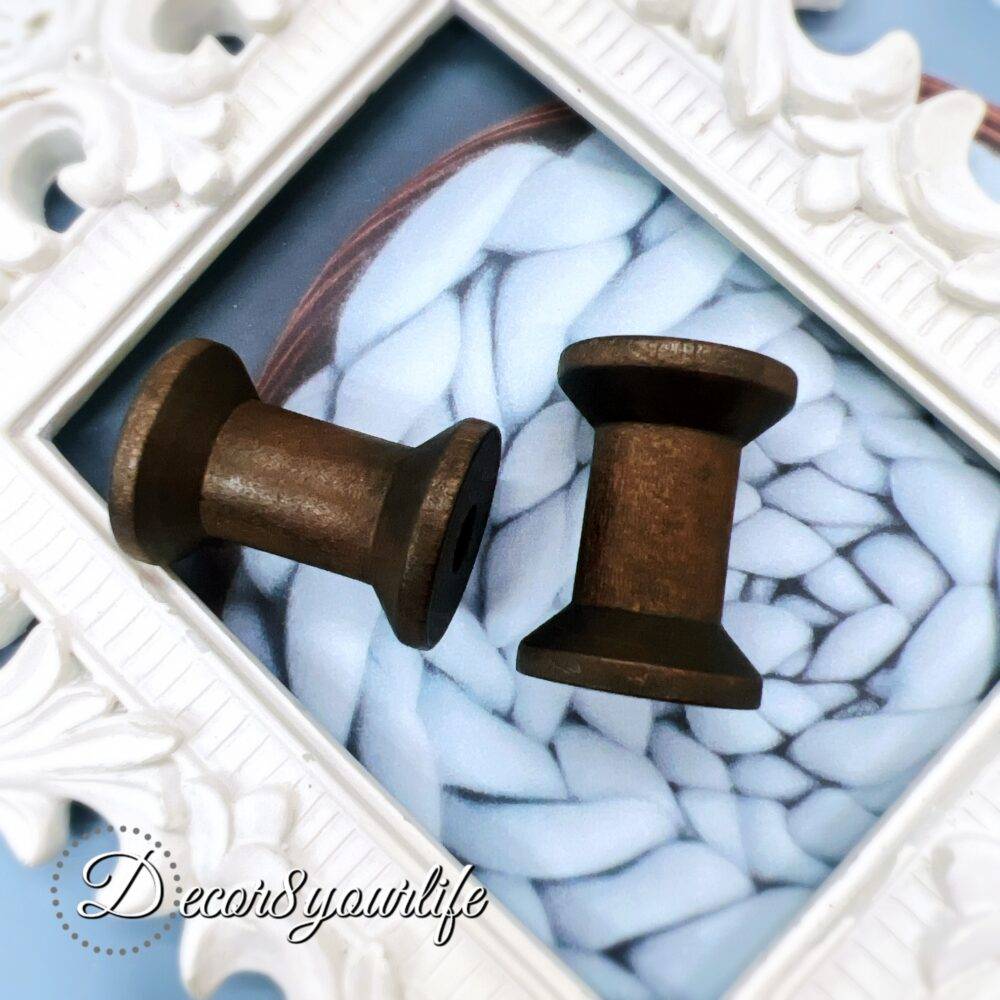 A set of two vintage-style wooden spools with a dark stained finish, perfect for scrapbooking, mixed media, and journal embellishments. Each spool measures approximately 1.25 inches tall.