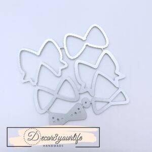 Small metal bow die-set with layered paper bow samples, ideal for scrapbooking, card making, and DIY crafts