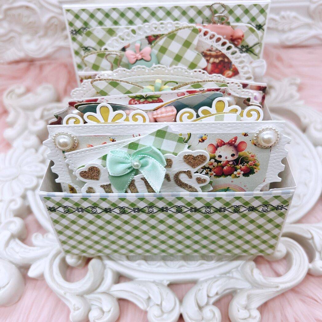 Inside view of a handmade memdex box album featuring layered and embellished memorydex cards using gingham and strawberry-themed paper from the 'Tasty Treats by Decor8yourlife' collection. Cards are decorated with ribbon bows, pearls, and die-cut shapes.