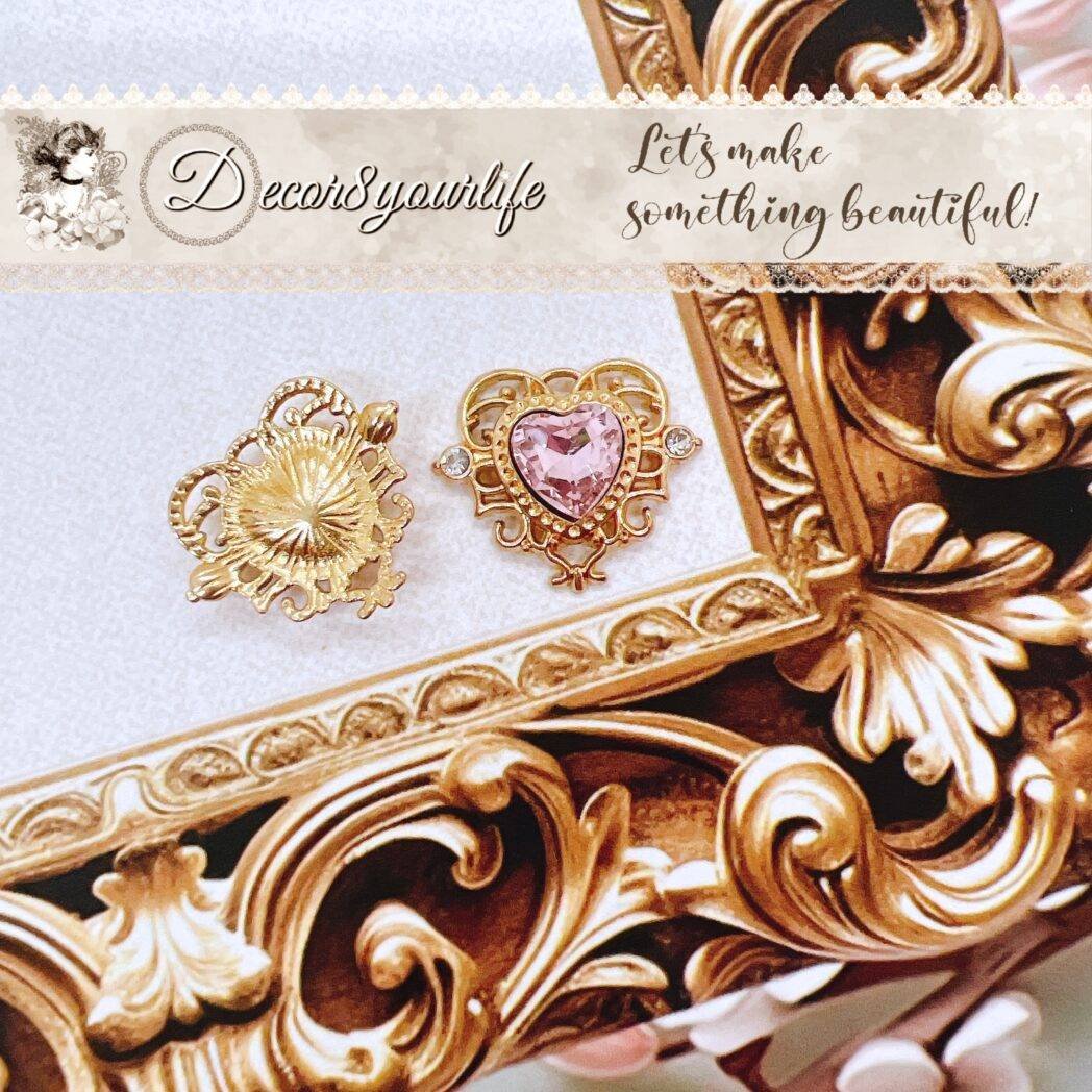 Flat-back gold-tone heart embellishment with pink faux stone center and rhinestone accents—ideal for shabby chic crafts, bridal décor, and home projects.