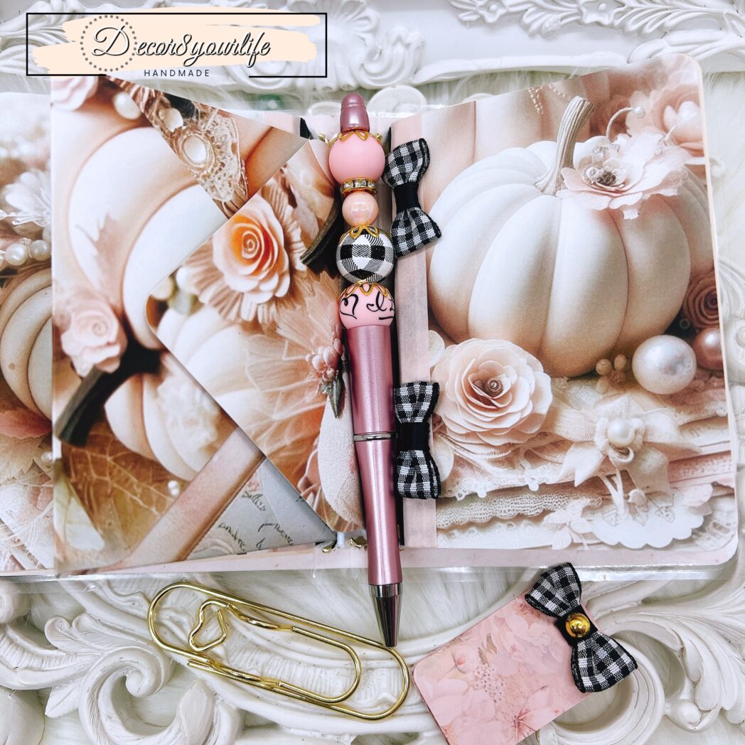 Handmade laminated traveler’s notebook with exclusive paper design, beaded pen, charms, and altered mini notebooks.