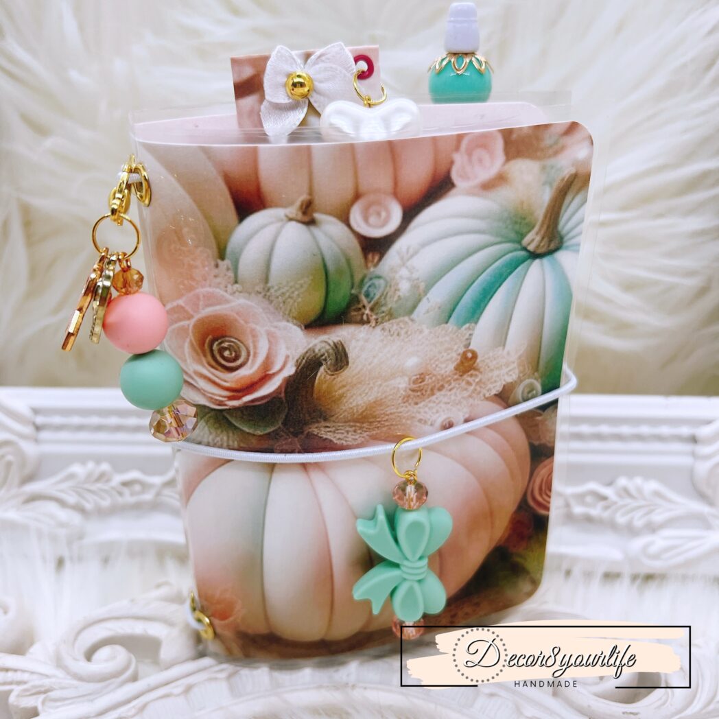 Exclusive handmade laminated traveler’s notebook with charms, beaded pen, pocket envelope, and altered mini notebooks.