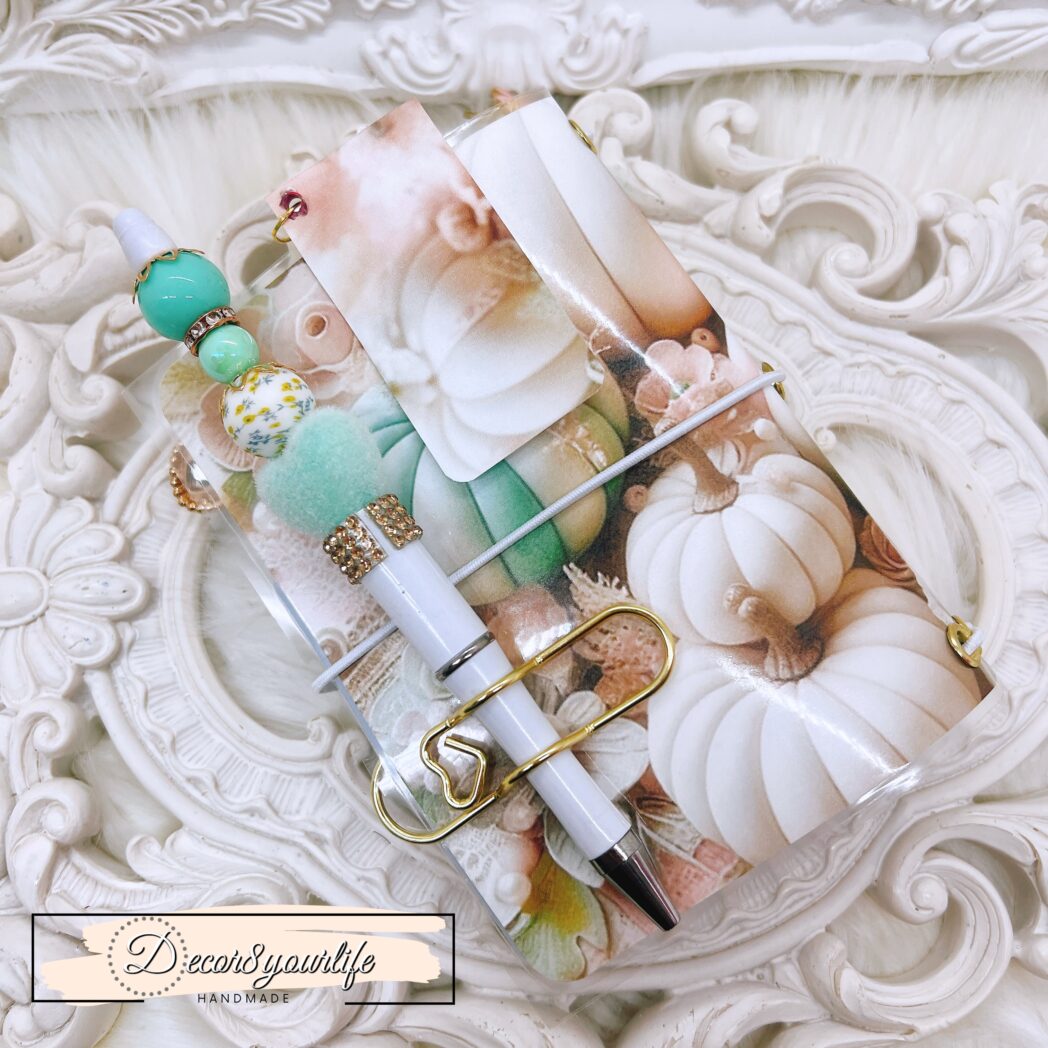 Exclusive handmade laminated traveler’s notebook with charms, beaded pen, pocket envelope, and altered mini notebooks.