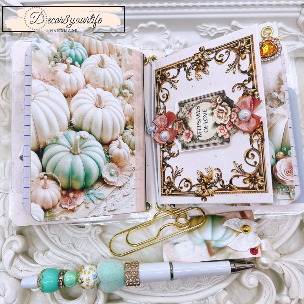Exclusive handmade laminated traveler’s notebook with charms, beaded pen, pocket envelope, and altered mini notebooks.