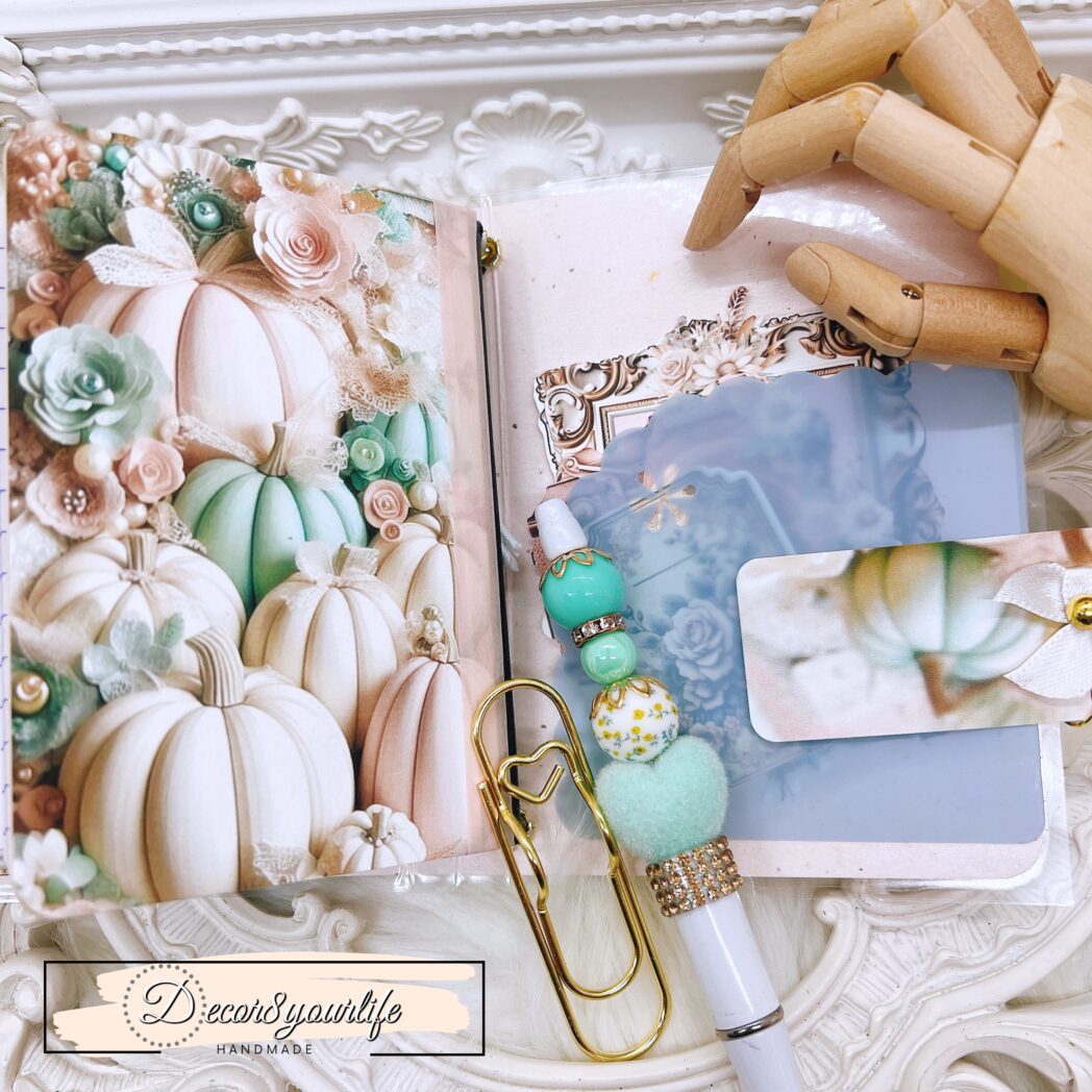 Exclusive handmade laminated traveler’s notebook with charms, beaded pen, pocket envelope, and altered mini notebooks.