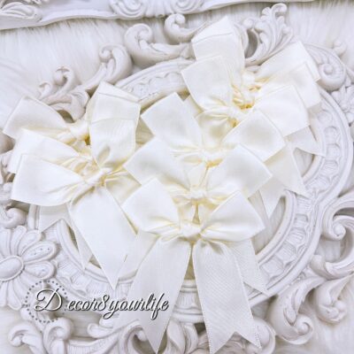 Cream color handmade satin bows that can be used for hair accessories, diy crafts, diy wedding crafts, or home decor projects.