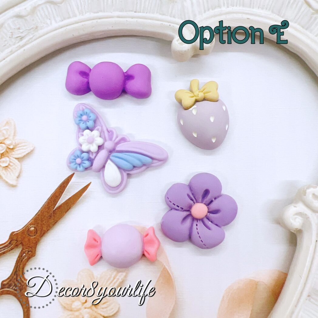 Pastel purple flat-back cabochons in assorted shapes including bunny, flower, strawberry, and candy pieces. Ideal for DIY crafts, planners, and resin projects.