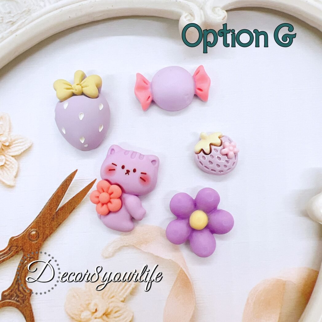 Pastel purple flat-back cabochons in assorted shapes including bunny, flower, strawberry, and candy pieces. Ideal for DIY crafts, planners, and resin projects.