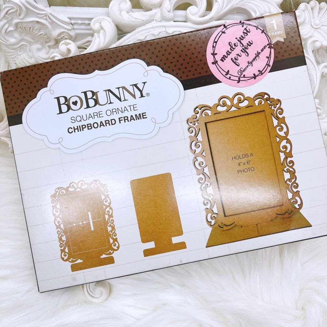 BoBunny square ornate chipboard frame kit packaging showing 4×6 photo frame with scrollwork and stand/easel pieces